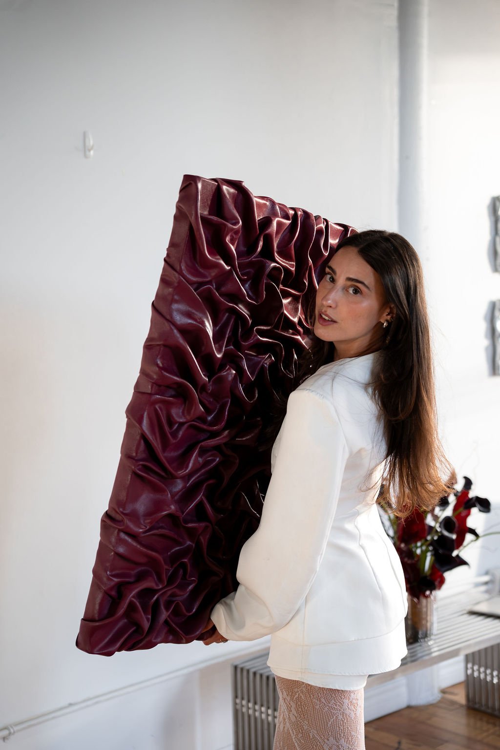 Elya portant une œuvre bordeaux